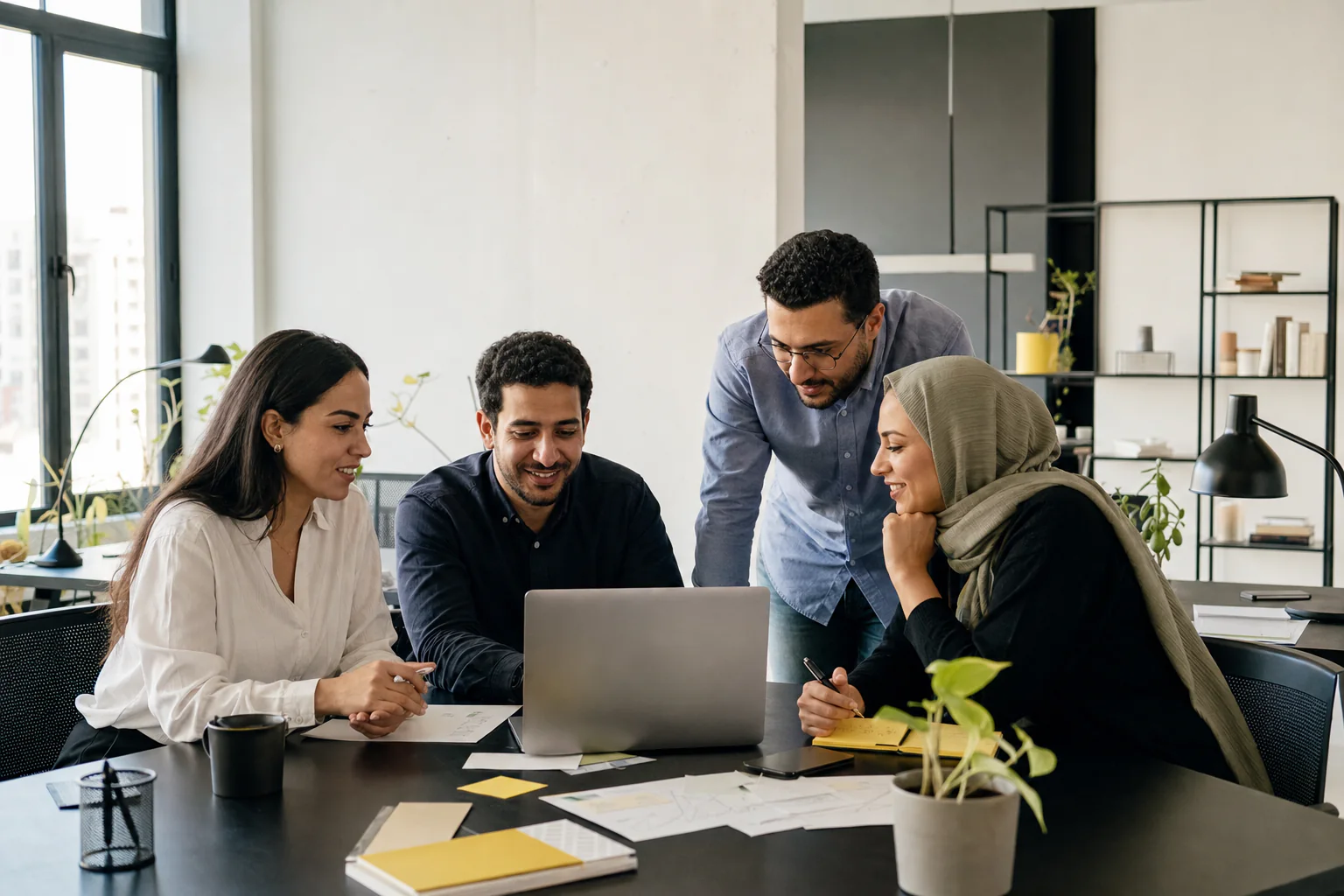 A team of Egyptian professionals collaborating around a worktable